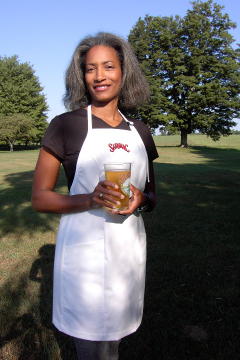 Women's Bib apron style W740; Shown in white, 100% cotton gabardine with two side hip, on seam pockets & embroidered Saranac logo on center chest.