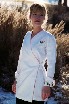 Women's Chef Coat Style BSW106: Shown in White, 100% cotton gabardine, Pink Sham piping (cuffs, collar & front), left sleeve tailored welt pocket & Rose embroidery (3 on each cuff & one on the left chest).