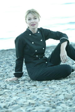 Women's Chef Coat Style CBW100: Shown in Black, 100% cotton Supima Gabardine, Natural White Piping (collar & cuffs), & Faux Mother-of-Pearl buttons