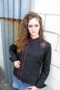 Cropped Women's Jacket Style CBW105H; Shown in black 100% cotton Supima Gabardine with two rows of Foxy Red piping along the collar and placket, one red tagua nut top button, spider embroidery on left front shoulder and square cuffs.